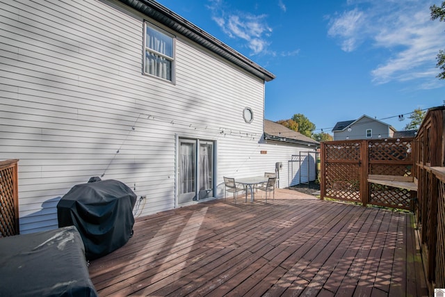 wooden terrace featuring area for grilling