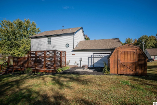 back of property with a storage unit, an outdoor fire pit, and a lawn