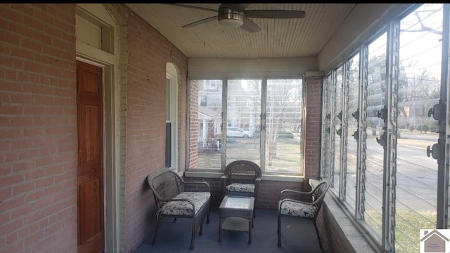 sunroom featuring ceiling fan