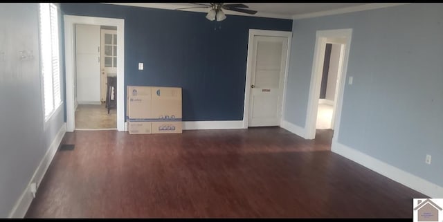 spare room featuring ceiling fan and dark wood-type flooring