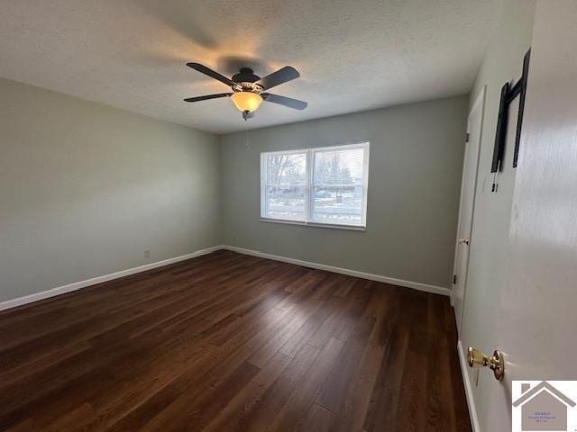 spare room featuring ceiling fan, dark hardwood / wood-style flooring, and a textured ceiling