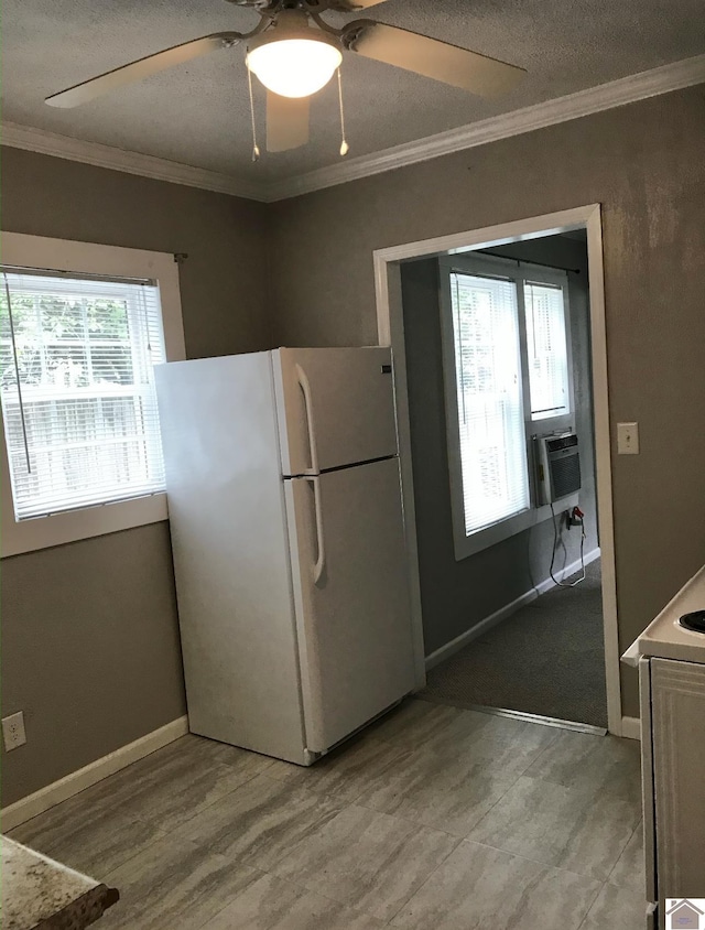 kitchen featuring cooling unit, crown molding, white fridge, and ceiling fan