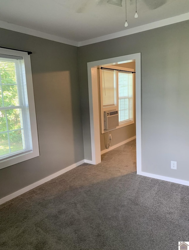 spare room with cooling unit, crown molding, and carpet