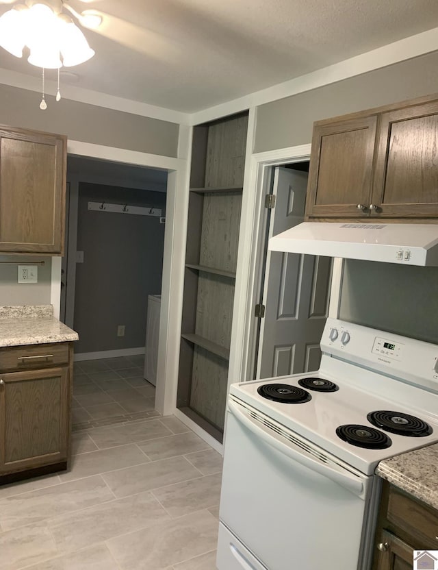 kitchen featuring ventilation hood and white range with electric stovetop