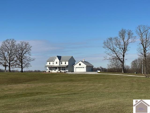 view of front of home with a front yard and a garage