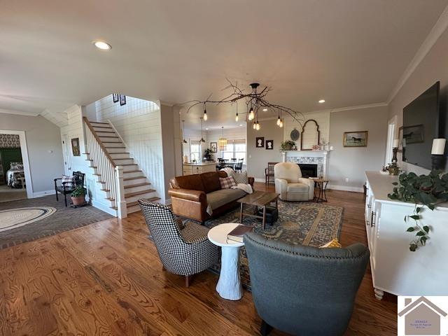 living room featuring ornamental molding and wood-type flooring