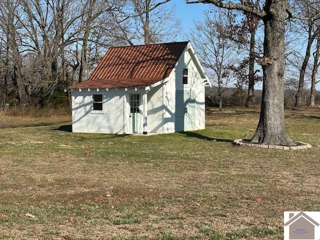 view of outbuilding with a lawn