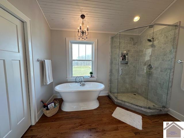 bathroom featuring a chandelier, wood ceiling, crown molding, separate shower and tub, and wood-type flooring