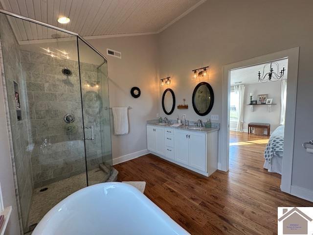 bathroom with hardwood / wood-style floors, vanity, ornamental molding, independent shower and bath, and lofted ceiling