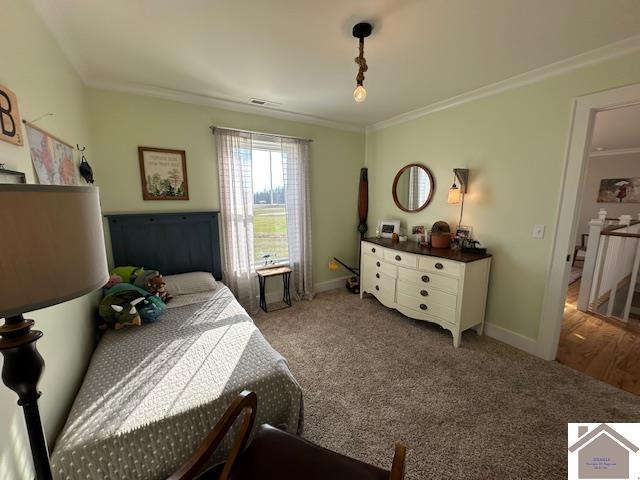 bedroom featuring ornamental molding and carpet floors