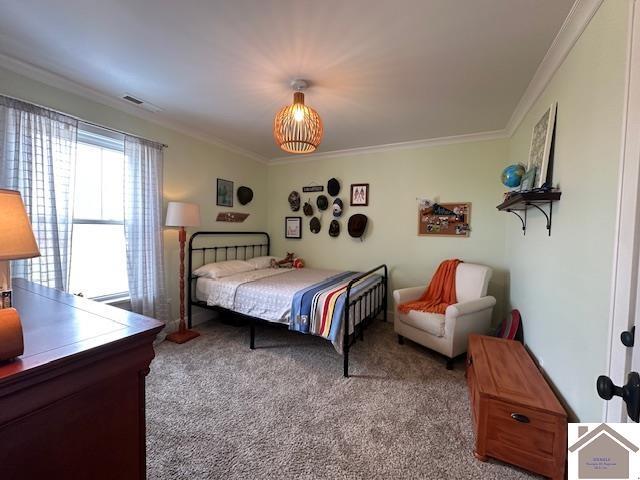 carpeted bedroom with ornamental molding