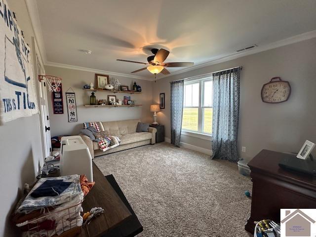 living room with ceiling fan, ornamental molding, and carpet