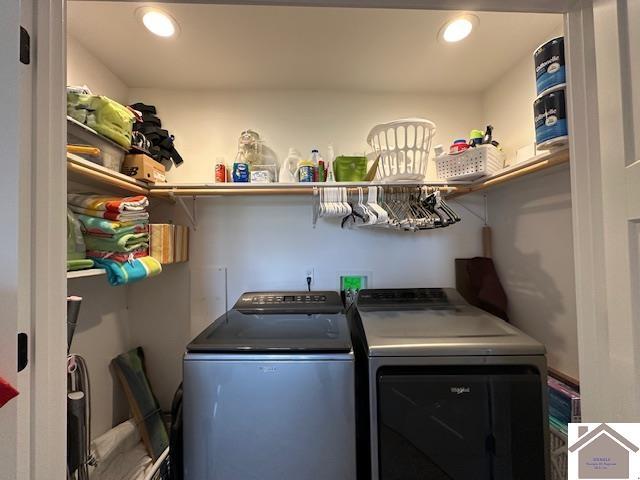 clothes washing area with washer and clothes dryer