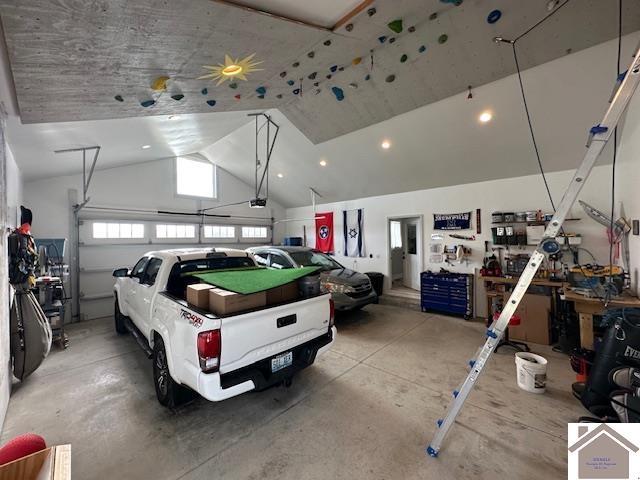 garage with a garage door opener and a workshop area