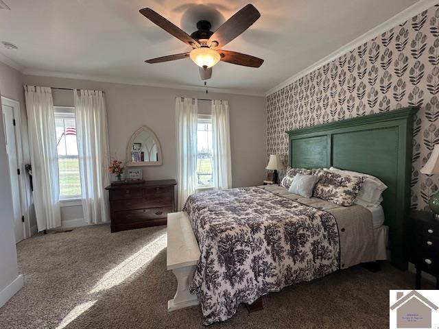 bedroom with dark colored carpet, ceiling fan, and crown molding