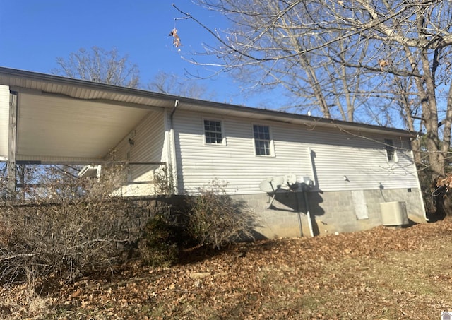 view of side of home featuring central AC unit