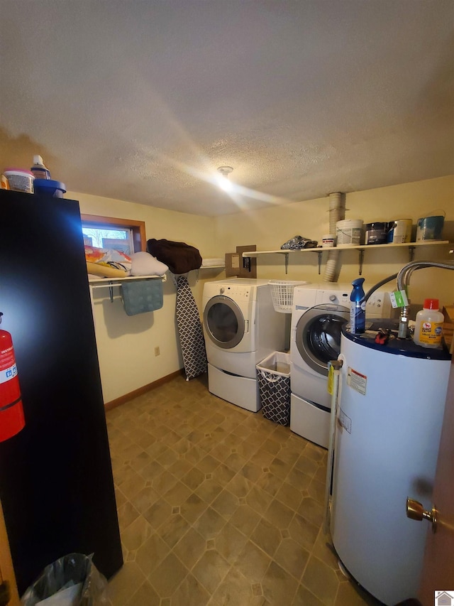 clothes washing area featuring a textured ceiling, water heater, and independent washer and dryer