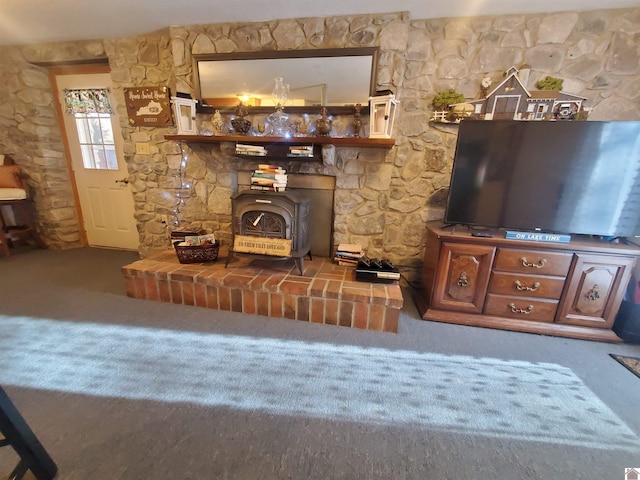 unfurnished living room with carpet floors and a wood stove