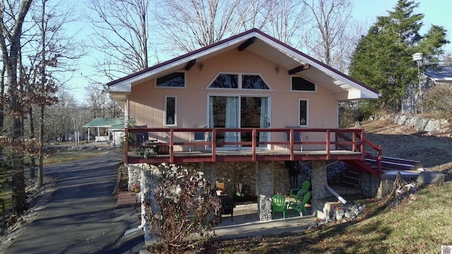 back of house featuring a wooden deck