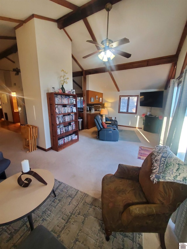 carpeted living room featuring ceiling fan and vaulted ceiling with beams