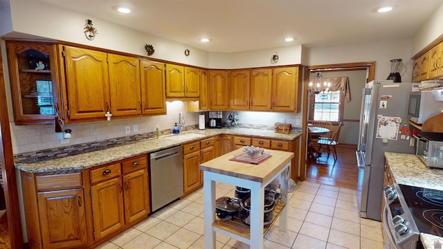 kitchen with light tile patterned floors, appliances with stainless steel finishes, wooden counters, and sink