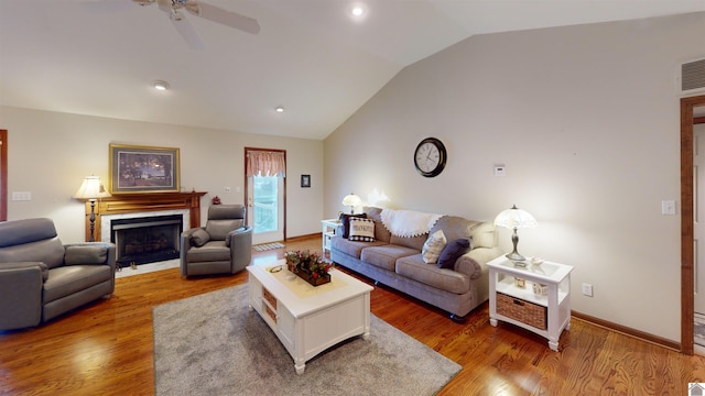 living room featuring vaulted ceiling, ceiling fan, and wood-type flooring