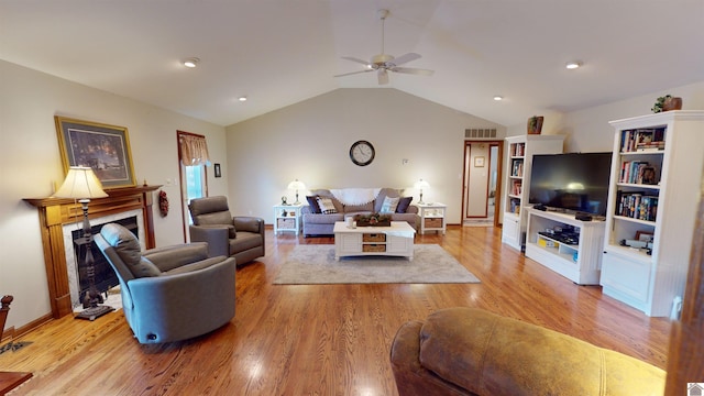 living room featuring ceiling fan, vaulted ceiling, and light hardwood / wood-style flooring