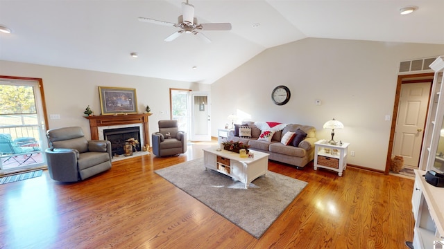 living room featuring ceiling fan, hardwood / wood-style floors, vaulted ceiling, and a healthy amount of sunlight