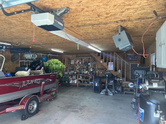 garage with a workshop area and a garage door opener