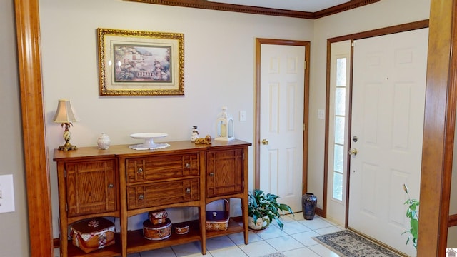 tiled foyer featuring ornamental molding