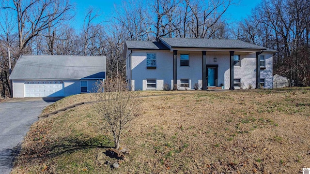 bi-level home with a front yard and a garage