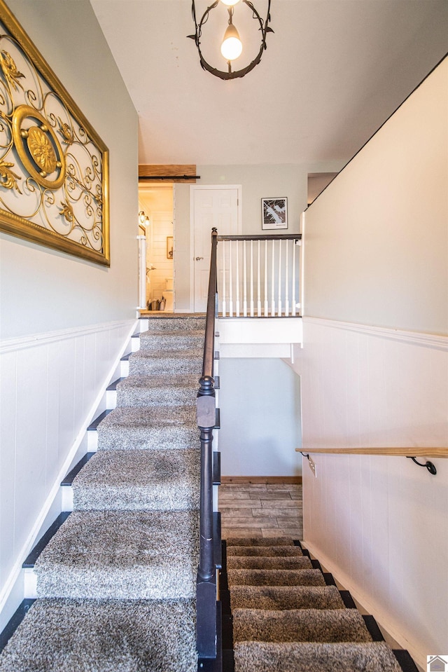 stairway with hardwood / wood-style floors