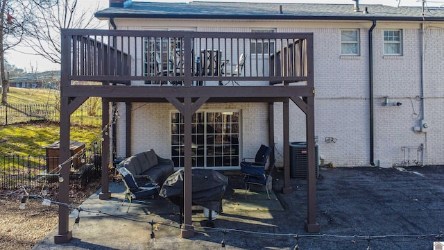 rear view of house featuring a patio, central AC unit, and a wooden deck