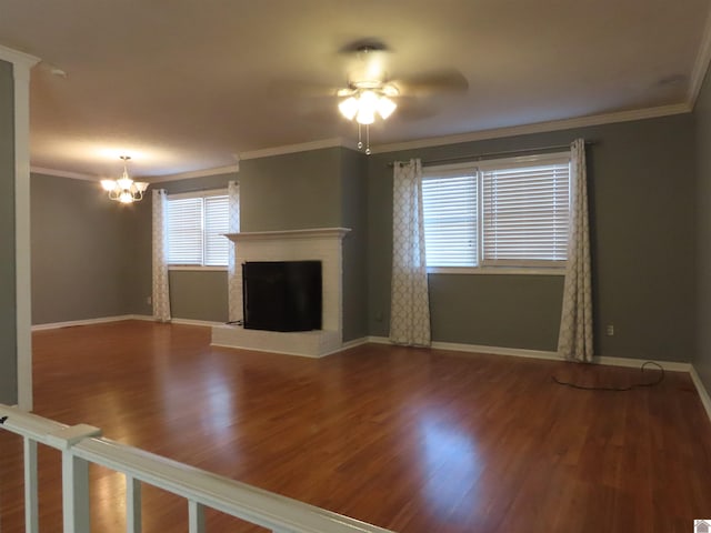 unfurnished living room with ornamental molding, ceiling fan with notable chandelier, and hardwood / wood-style flooring