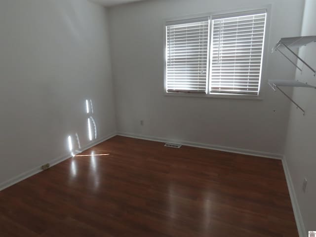 spare room featuring dark hardwood / wood-style floors