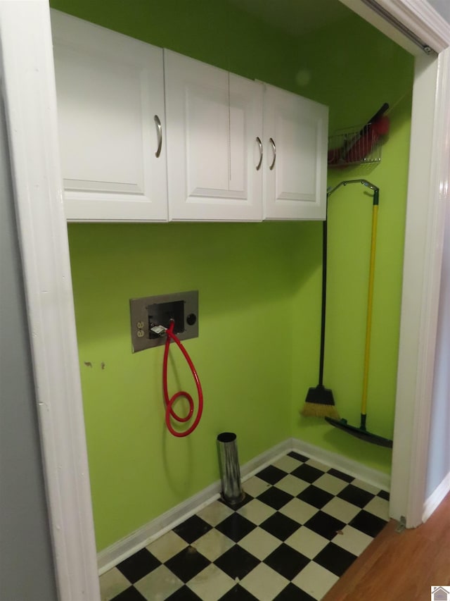 clothes washing area featuring washer hookup and cabinets