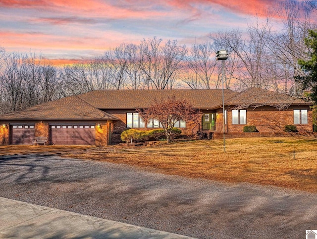 view of front of house featuring a lawn and a garage