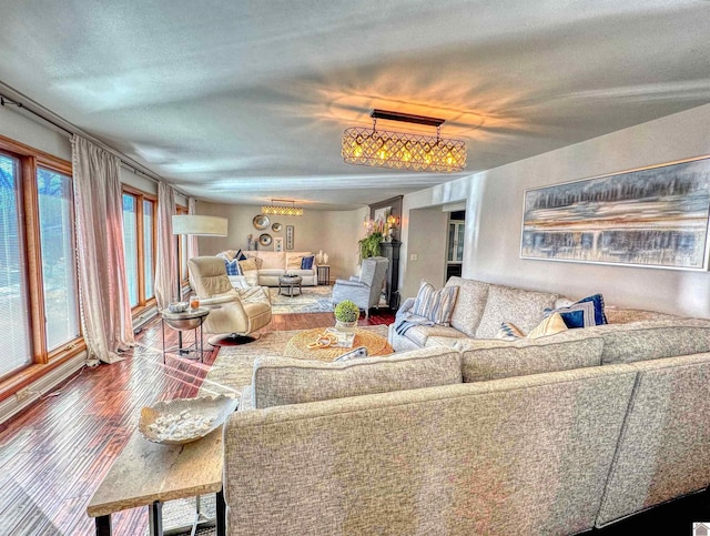 living room featuring a wealth of natural light, a chandelier, and hardwood / wood-style flooring