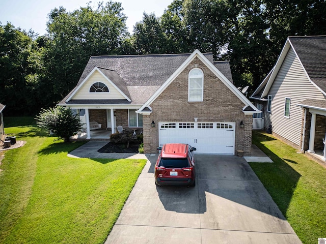 view of front of house with a garage, a front yard, and covered porch