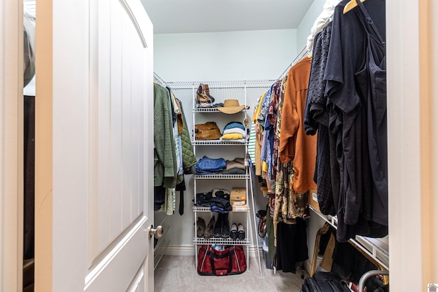 walk in closet with carpet