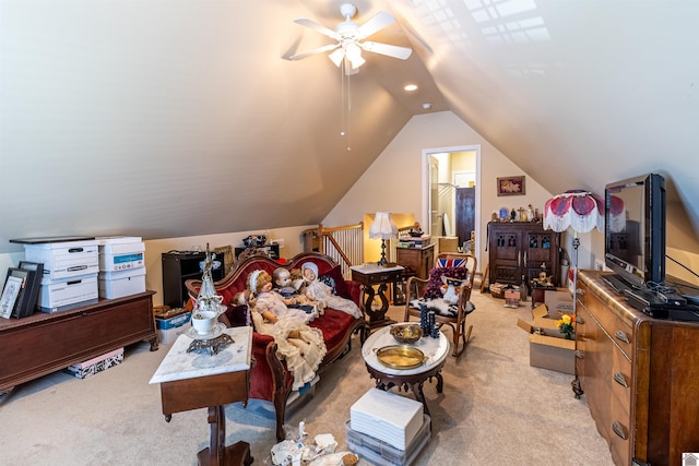 interior space featuring vaulted ceiling, ceiling fan, and light colored carpet