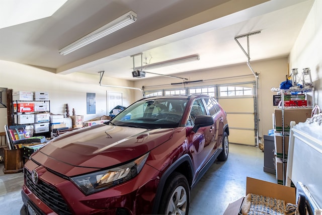 garage featuring electric panel and a garage door opener