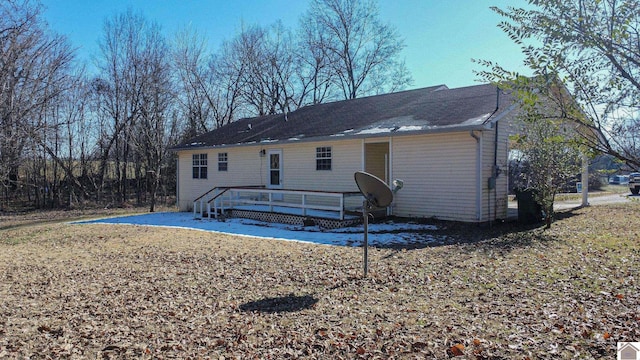 back of house featuring a wooden deck