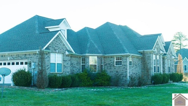 view of side of property featuring a yard and a garage