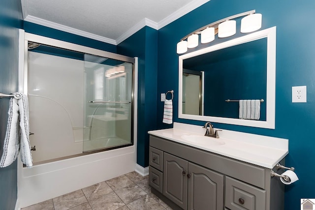 bathroom with a textured ceiling, ornamental molding, vanity, and shower / bath combination with glass door