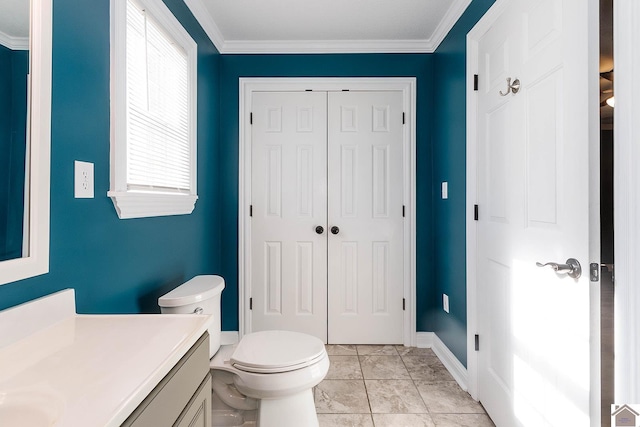 bathroom featuring tile patterned floors, vanity, crown molding, and toilet