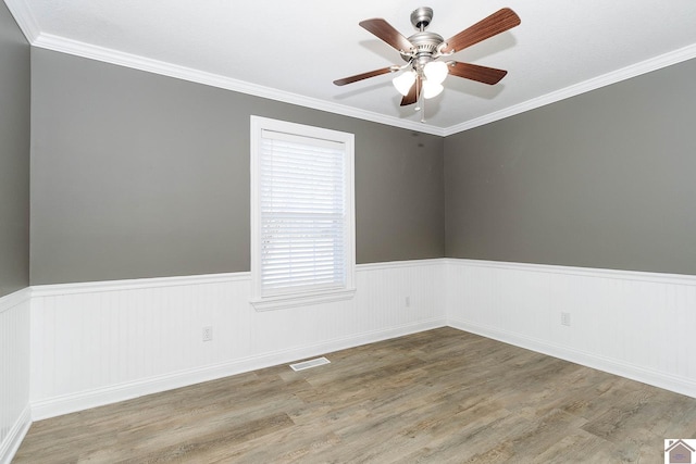 unfurnished room featuring ceiling fan, wood-type flooring, and crown molding