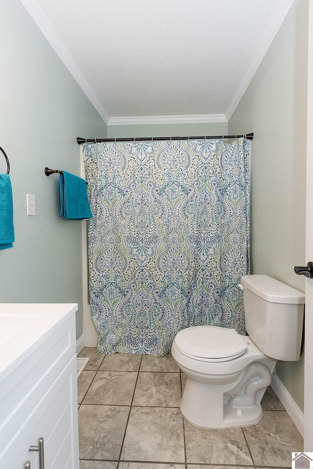 bathroom with a textured ceiling, tile patterned flooring, vanity, toilet, and ornamental molding