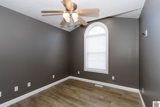 spare room featuring ceiling fan, a textured ceiling, and dark hardwood / wood-style flooring