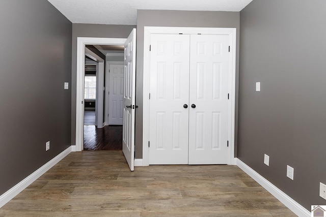 hall with wood-type flooring